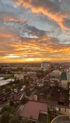 a city with traffic on a street at sunset at YourSafeHaven in Manila