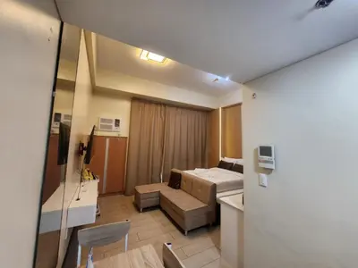 a small room with a bed and a couch at Two Palm Tree Villas Across NAIA Terminal 3 in Manila