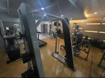 a gym with a bunch of treadmills and machines at Two Palm Tree Villas Across NAIA Terminal 3 in Manila