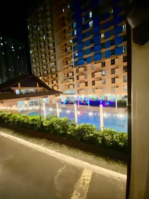 a view of a swimming pool at night at Condo in Manila in Manila