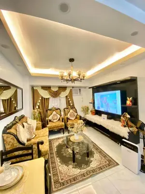 a living room with a couch and a tv at Condo in Manila in Manila