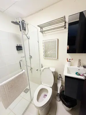a bathroom with a toilet and a shower and a sink at Apartment in Pasig-khairo Residences in Manila
