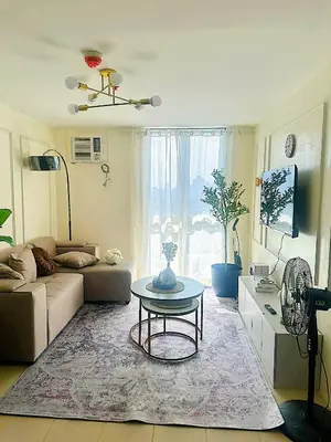 a living room with a couch and a table at Apartment in Pasig-khairo Residences in Manila