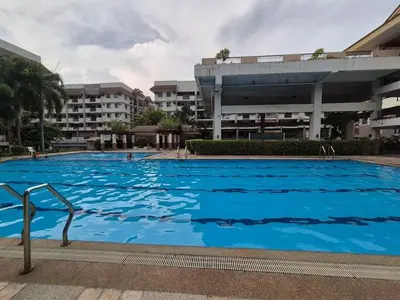 a large blue swimming pool in front of a building at JeweIs Homey Place -2br in a resort-like condo in Manila