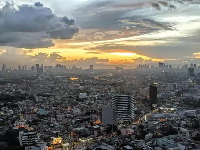 a view of a city at sunset at Metro Lounge Studio - Cozy Urban Living in Manila