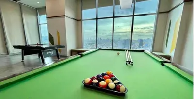 a billiard room with a pool table with balls on it at Metro Lounge Studio - Cozy Urban Living in Manila