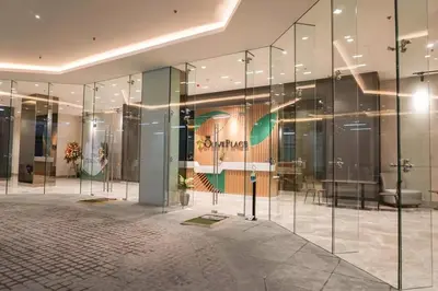 a lobby of a building with glass walls at Metro Lounge Studio - Cozy Urban Living in Manila