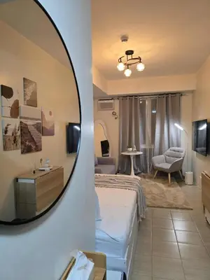 a room with a bed and a mirror at Queen's Escape in Manila