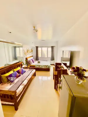 a large living room with a bed and a couch at Sea Residences Condominium in Manila