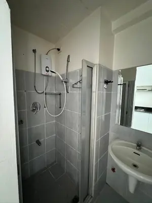 a bathroom with a shower and a sink at Sea Residences Condominium in Manila