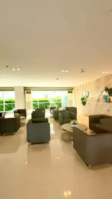 a living room with couches and chairs and tables at Sea Residences Condominium in Manila