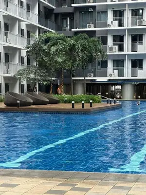 a large swimming pool in front of a building at EyaLove's Staycation in Manila