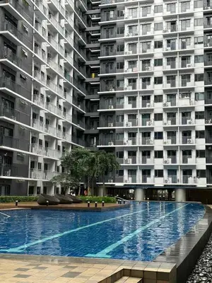 a large apartment building with a large swimming pool at EyaLove's Staycation in Manila