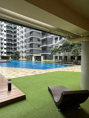 a patio with a chair and a swimming pool at EyaLove's Staycation in Manila