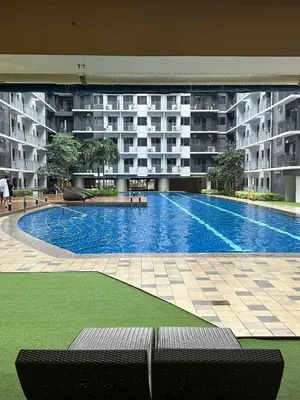a large swimming pool in front of a building at EyaLove's Staycation in Manila