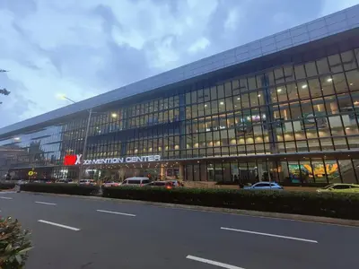 a large building with cars parked in front of it at SEA RESIDENCES CONDOTEL by Tvans in Manila