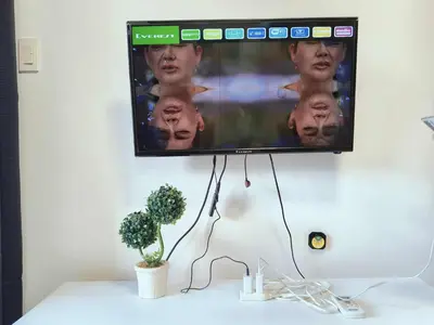 a flat screen tv hanging on a wall at SEA RESIDENCES CONDOTEL by Tvans in Manila