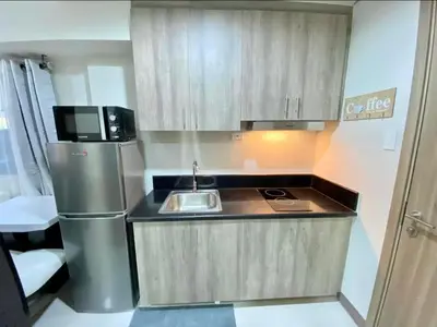 a small kitchen with a sink and a refrigerator at SMDC Coast Residence in Manila