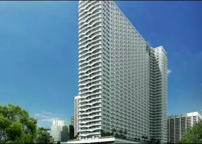 a tall building with many windows in a city at SMDC Coast Residence in Manila