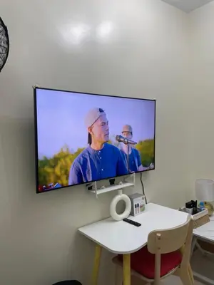 a flat screen tv hanging on a wall at Stylish and Cozy Condo Near Mall of Asia in Manila