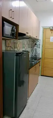 a kitchen with a stainless steel refrigerator and a microwave at Close by landmarks and airport in Manila