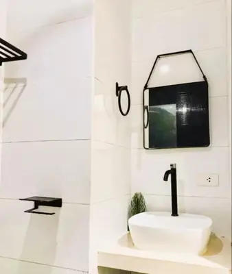 a white bathroom with a sink and a mirror at Close by landmarks and airport in Manila