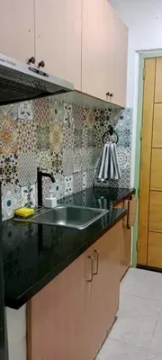 a kitchen with a black counter top and a sink at Close by landmarks and airport in Manila