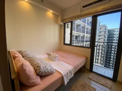 a small room with a bed and a large window at The Nuebe Chalet near SM Moa Pasay City in Manila