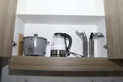 a cupboard with a blender and a appliance on it at The Nuebe Chalet near SM Moa Pasay City in Manila
