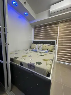 a bedroom with a bed in a room at Bellas Place Shell Residences MOA in Manila