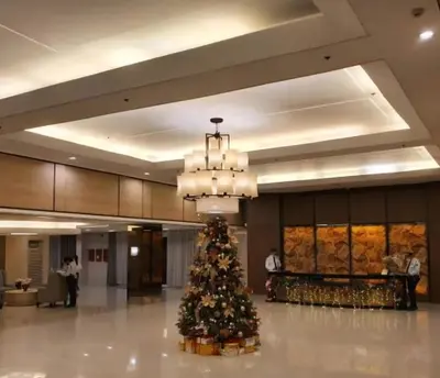 a christmas tree in the middle of a lobby at Bellas Place Shell Residences MOA in Manila