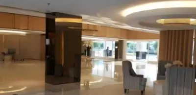 a living room with a couch and a chair at Bellas Place Shell Residences MOA in Manila