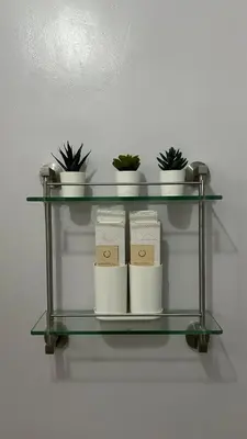 a glass shelf with three pots and plants on it at Condo Unit at La Verti Residences in Manila