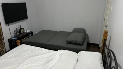 a living room with a bed and a couch at Condo Unit at La Verti Residences in Manila