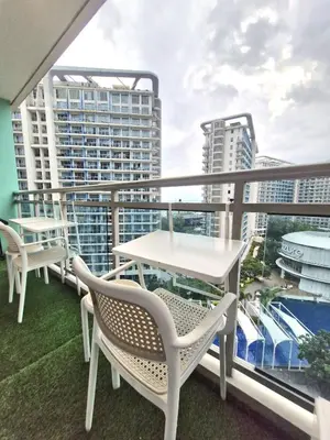 a balcony with tables and chairs and buildings at 2BR Unit Azure Urban Resort Residences in Manila