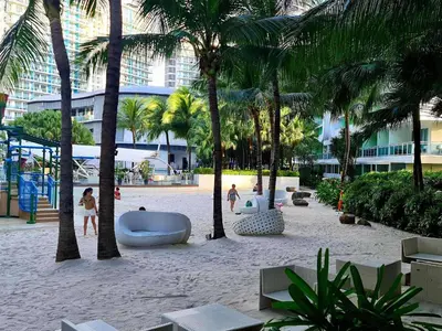 a beach with palm trees and a volley ball court at 2BR Unit Azure Urban Resort Residences in Manila
