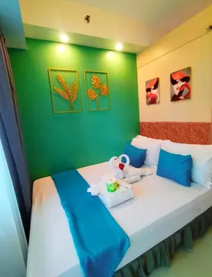 a bedroom with a bed with a stuffed animal on it at Comfystay at Sea Residences tower C in Manila