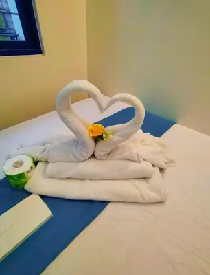 two towels in the shape of swans on a bed at Comfystay at Sea Residences tower C in Manila