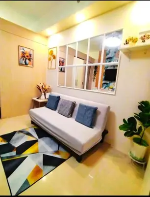 a living room with a couch and a mirror at Comfystay at Sea Residences tower C in Manila