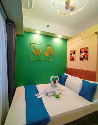 a bedroom with a bed with a stuffed animal on it at Comfystay at Sea Residences tower C in Manila