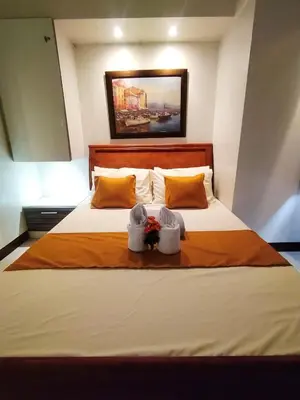 a bedroom with a large bed with two baskets on it at Comfystay at Sea residences 2 bedrooms in Manila