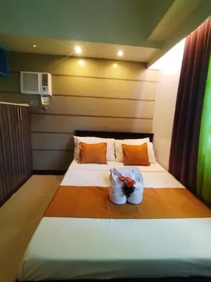 a bed in a room with two bags on it at Comfystay at Sea residences 2 bedrooms in Manila