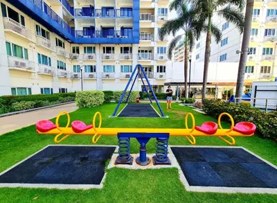 a playground in front of a large building at Comfystay at Sea residences 2 bedrooms in Manila