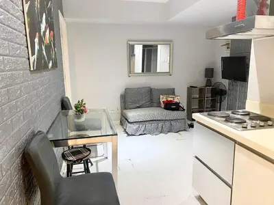 a small living room with a table and a couch at 2bedroom azure beachview 7 in Manila