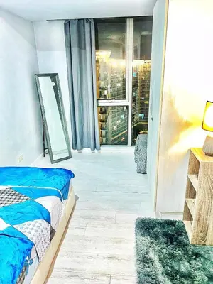 a bedroom with a bed and a large window at 2bedroom azure beachview 7 in Manila