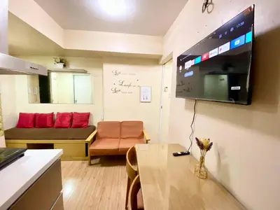 a small living room with a table and a couch at 2 bedroom azure cityview 1 in Manila