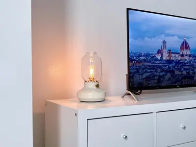 a lamp sitting on a dresser next to a television at Sky Piea at Knightsbridge Residences - APARTMENT with Gym Sauna Pool in Manila