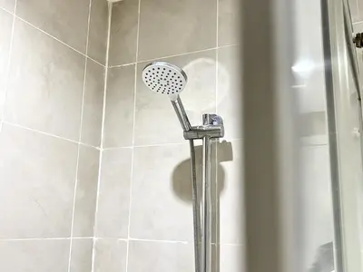 a shower with a shower head in a bathroom at Sky Piea at Knightsbridge Residences - APARTMENT with Gym Sauna Pool in Manila