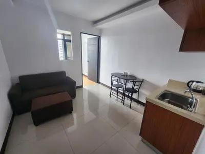 a living room with a couch and a table at Bayport Luxhome in Manila