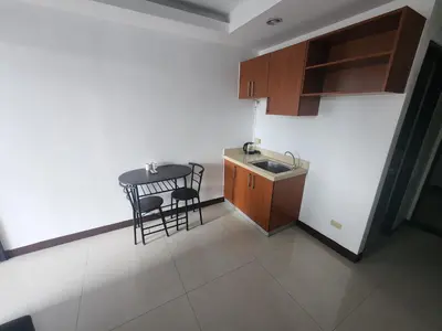a small kitchen with a table and a sink at Bayport Luxhome in Manila